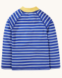 The back of the Frugi Rash Vest Sun Safe - Shark.  A blue sun-safe rash vest with a yellow neck, blue and white striped arms and white and blue stripes on the back, on a cream background. This rash vest passes British Sun-safe standards UPF 40+ and is mad