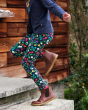 Close up of a child running up some stairs wearing the Frugi indigo floral print libby leggings