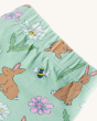 A close up view of the elasticated waste band on the Frugi Little Libby Printed Leggings - Riverine Rabbits, made from GOTS Organic Cotton. A beautiful spring-time print of yellow, white and pink flowers, bees, ladybirds and brown bunnies, and on a light 