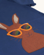 A closer view of the Frugi Carsen Applique T-Shirt - Hare. A deep navy blue GOTS organic cotton t-shirt with a brown hare wearing yellow sunglasses with a rainbow reflection in the lens