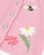 A closer look at the flower and bee applique detail on the pink, knitted Frugi Colby Cardigan - Jellyfish / Rabbit, with light grey buttons.