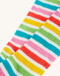 A closer look at the material and rainbow stripes on the leg section of the Frugi Organic Hygge Knee High Socks - Rainbow. Colourful rainbow striped knee high long socks, with white, pink, red, yellow, green and blue rainbow stripes, on a cream background
