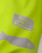 Close up of the reflective frugi logo on the frog print puddle buster waterproof trousers