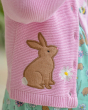 A closer view of the rabbit and flower applique detail on the pink, knitted Frugi Colby Cardigan - Jellyfish / Rabbit.