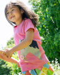 A child happily playing in the sunshine wearing the Frugi Children's Organic Cotton Elise Applique T-Shirt - Horse. A pink t-shirt with cap sleeves and gorgeous applique horse and flower detailing and soft rib neck