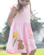 A child walking in the sun with their hands behind their back, whilst wearing the Frugi Bobby Dress - Jellyfish Breton / Rabbit. Made with GOTS Organic Cotton, this is a cheerful pink and white stripe dress, with a rabbit, daffodil and white daisy flower 