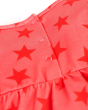 Close up of the popper closure on the Frugi childrens red star dolcie dress