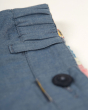 Close up of the belt loops on the Frugi eco-friendly reversible rhys shorts on a white background
