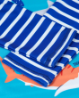 A close up view of the stitching and blue/white stripe sleeves of the Frugi Rash Vest Sun Safe - Shark.  This rash vest passes British Sun-safe standards UPF 40+ and is made with Recycled fibers.