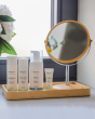 Green People Skin Care range, stood on a wooden table next to a mirror