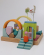 A beautiful house play scene created by using the Grimm's Cloud Play set. The wooden tray base has been used as the house foundation, and the colourful and natural blocks are inside to create the play scene. Two Grimm's friends are relaxing at the house, 