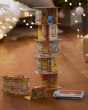 The HABA Rhino Hero Card Stacking Game, sacked high on a wooden floor with fairy lights in the background