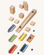 A view of each block and marble in the HABA Wooden Melodious Marble Run set, on a cream background