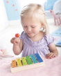 Haba Musical Metallophone, Xylophone Toy Instrument. A child happily creating music with the Haba Musical Metallophone, Xylophone Toy Instrument, in a play room