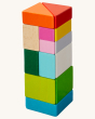 A beautiful and colourful tower built by using the HABA Tangram Blocks, on a cream background