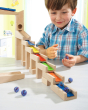 A child happily making music with the HABA Wooden Melodious Marble Run