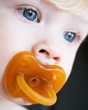 Close up of a baby sucking on the Hevea natural rubber baby dummy