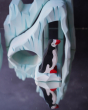 Holztiger Penguin figure stood in front of the Bumbu icy cliffs 