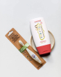 Jack N' Jill Fluoride-Free Strawberry Toothpaste 200g pictured next to toothbrush with monkey motif