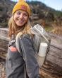 Woman smiling and wearing a rucksack with a Klean kanteen 500ml steel tkpro flask in the side pocket