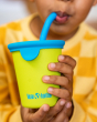 Close up of a child drinking from the Klean Kanteen reusable stainless steel straw cup in the green and blue colour