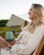 Woman sat in a wooden chair holding a Klean Kanteen plastic-free wine tumbler