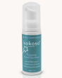 A bottle of Kokoso Foaming Hand Sanitiser, On the Go, 50ml in the middle of the picture on a cream background