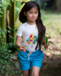 A child playing among the tress holding a bunch of leaves in their hand, wearing the Little Green Radicals Blue Moon By The Sea Twill Shorts. made from GOTS organic Cotton, these beautiful blue shorts have a white and yellow drawstring cord in the waistba