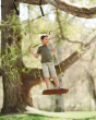 Boy stood on the Lillagunga walnut grand swing hanging from a large tree in a park 
