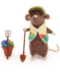 A closer look at the details on The Makerss Needle Felt Gardening Mouse. A beautifully crafted brown mouse wearing a green hat and floral gardening coat, holding spade, with a rake and small flowerpot and felt flowers opposite, on a white background