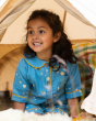 A child playing happily in a tent, wearing the Little Green Radicals Organic Cotton Dusk Button Through Pyjama Short Set. Made from GOTS organic Cotton, these beautiful light blue pyjama shorts and top have delicate stars and moon designs
