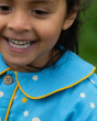 A closer view of the collar with yellow rim, star detail and button on the Little Green Radicals Organic Cotton Dusk Button Through Pyjama Short Set. Made from GOTS organic Cotton, these beautiful light blue pyjama shorts and top have delicate stars and m