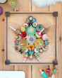 Mader handmade Manege wooden spinning plate on a wooden floor covered in various Mader spinning top toys