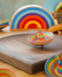 Mader eco-friendly wooden sombrero spinning top twirling around on a mader spin plate in front of a lanka kade x babipur sunset