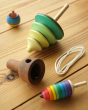 Mader kids wooden pull string tree spinning top toy on a wooden background