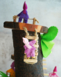 One of the pose-able Magic Wood elves climbing up the rope ladder on the Magic Wood log tree cave. Another can be seen stood up in the background