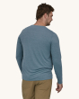 An adult wearing a Patagonia Men's Long-Sleeved Capilene Cool Daily Graphic Shirt in blue showing the fit of the top from the back