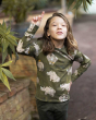 Meyadey Roaming Rhino organic long sleeved top in deep mossy green with detailed rhino and savannah plants print. For by child with long hair, pointing to the sky, plants to the side