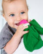 Close up of a baby holding the Oli & Carol natural rubber radish baby teether in it's mouth