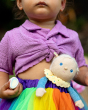 A child has Bonnie Buttercream tucked away in a colourful rainbow skirt band