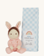 Olli Ella Dinky Dinkum Doll Fluffles - Bella Bunny, wearing a fluffy pink all in one with fluffy bunny ears, and blue packaging on a  cream background