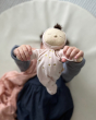 Olli Ella Lullaby Dozy Dinkum Doll - Luna is being held by both hands by a child wearing a blue dress.