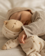 Close up of Olli Ella Lullaby Dozy Dinkum Doll - Lyra, with a baby cuddling the doll asleep.