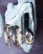 Ostheimer penguin family figures stood on a refelective surface in front of the Bumbu icy cliffs 
