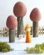 Papoose rainbow gnome figure and mini bunny toy on a white background next to some Papoose autumn earth trees