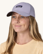 An adult wearing the Patagonia Airshed Baseball Cap - Herring Grey. The hat shows the Patagonia Logo on the front of the hat