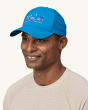 Patagonia Airshed Hat in Vessel Blue, on an adults head showing the colourful front Patagonia logo 