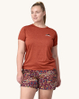 An adult showing the swift on the front of the Patagonia Women's Capilene Cool Daily Graphic Shirt. This photo shows the fit of the t-shirt from the front