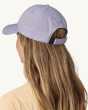 The back of the Patagonia Airshed Baseball Cap. The hat is being worn by an adult and shows the Velcro fastening on the back of the hat to change the hat size