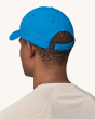Patagonia Airshed Hat in Vessel Blue on an adults head, showing the velcro fastener at the back of the hat